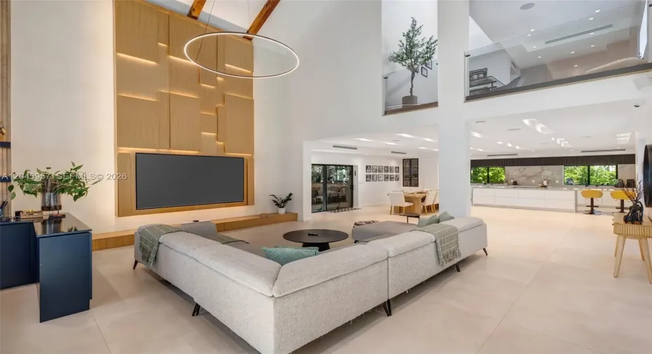 Every detail reflects thoughtful craftsmanship, from the custom millwork and integrated media wall to the dramatic ceiling heights that define the home’s architectural character.