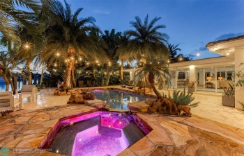 Outdoor oasis with hot tub, heated pool and tiki bar.
