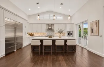 Refined neutral kitchen with ivory stool