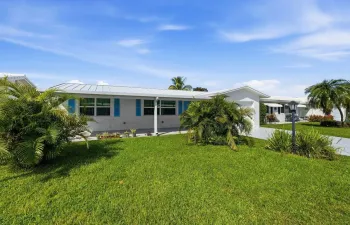 Lovely ranch style home with newer metal roof and impact windows and doors