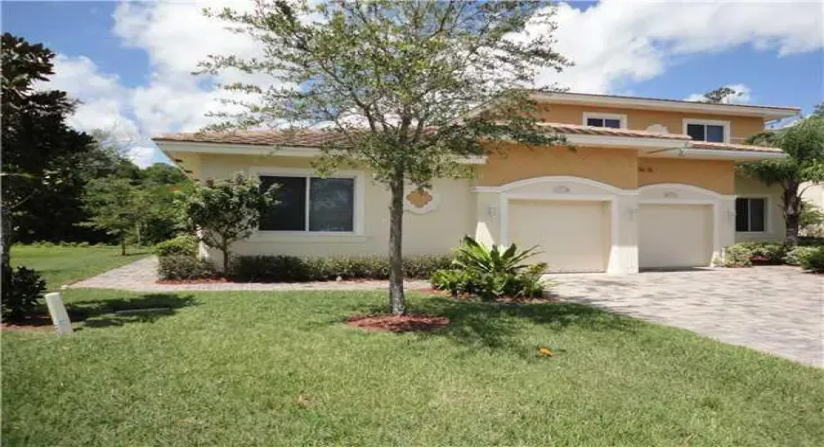 Exterior front, corner unit, 1 story. Metal roof. 1 ar garage parking.