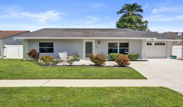 Single-story exterior with stucco finish and a composite shingle roof