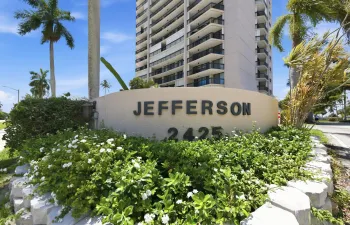Building exterior featuring tropical landscaping