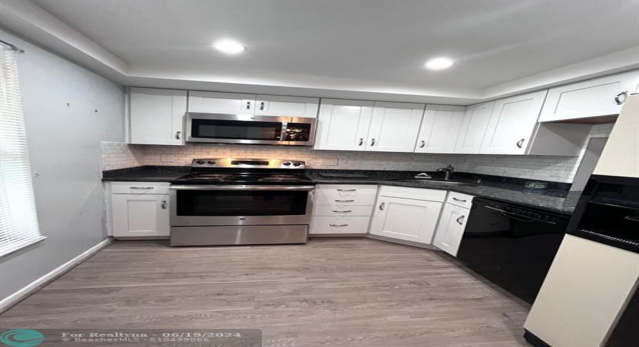 Updated Kitchen with Recessed Lighting, Laminate Floors , SS Appliances, Large SS Sink , Granite countertops
