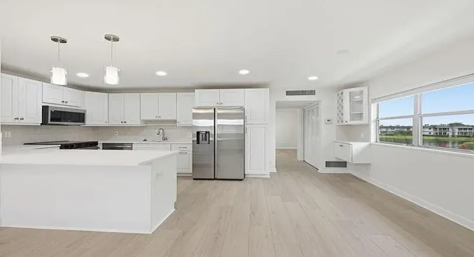 Modern kitchen with white cabinetry and stainless steel appliances