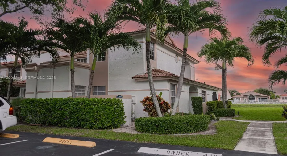Side view with landscaped grounds and convenient nearby parking.