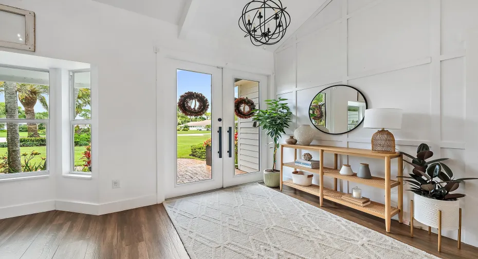 Wood-look tile flooring with a white board and batten accent wall