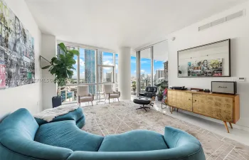 Floor-to-ceiling windows, white tile flooring, sliding glass door, white walls, and recessed lighting