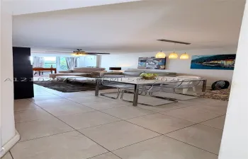 Ceramic tile flooring, three-light linear pendant fixture, ceiling fan with integrated lighting, and neutral wall color