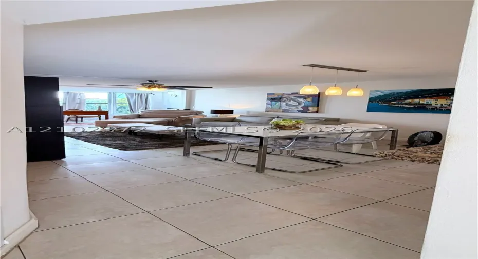Ceramic tile flooring, three-light linear pendant fixture, ceiling fan with integrated lighting, and neutral wall color
