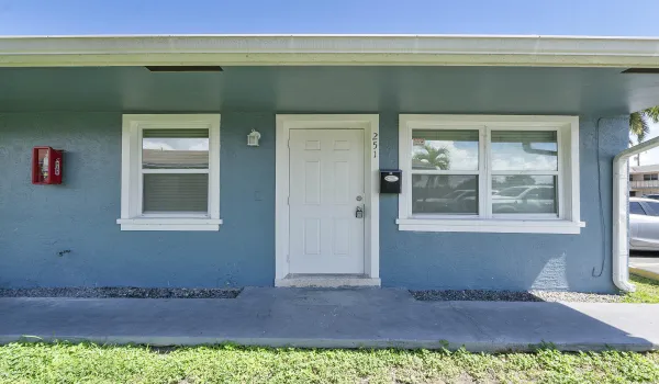 White paneled entry door with unit numbers