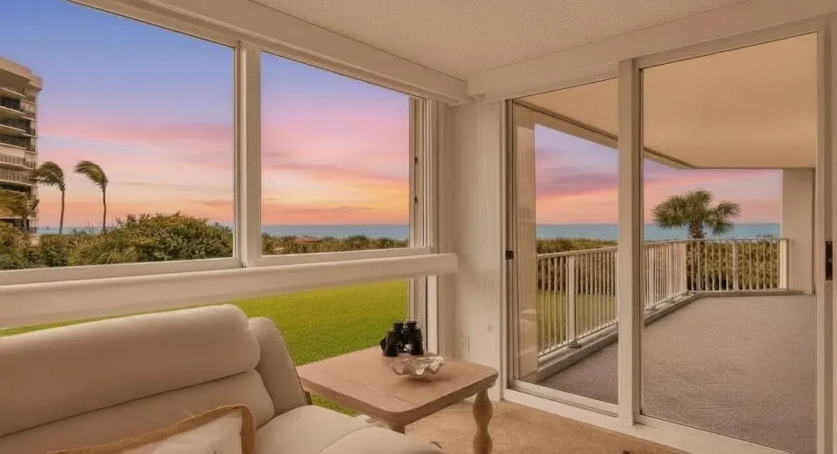 Twilight enhancement. Balcony and large picture window have accordion shutters.