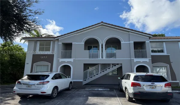 Two-story stucco building with a tiled roof