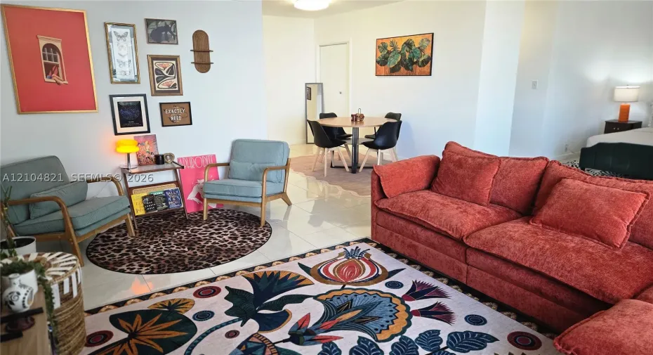 White tiled flooring, recessed lighting, and a dining area with a round table