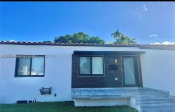 White stucco exterior with a terra cotta tile roof