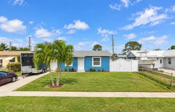 Single-story residence featuring a blue exterior, white trim, and a white front door