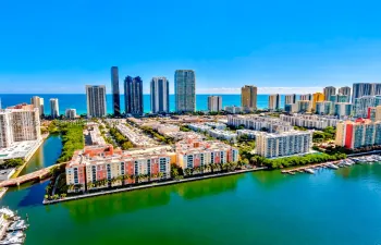 Waterfront community with a marina, surrounded by urban architecture and direct ocean access
