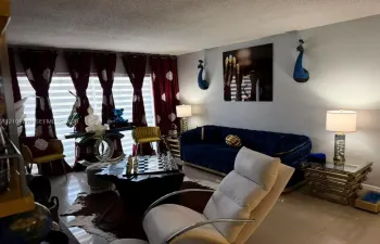 Recessed ceiling, large windows with vertical blinds, tiled flooring, and neutral wall paint