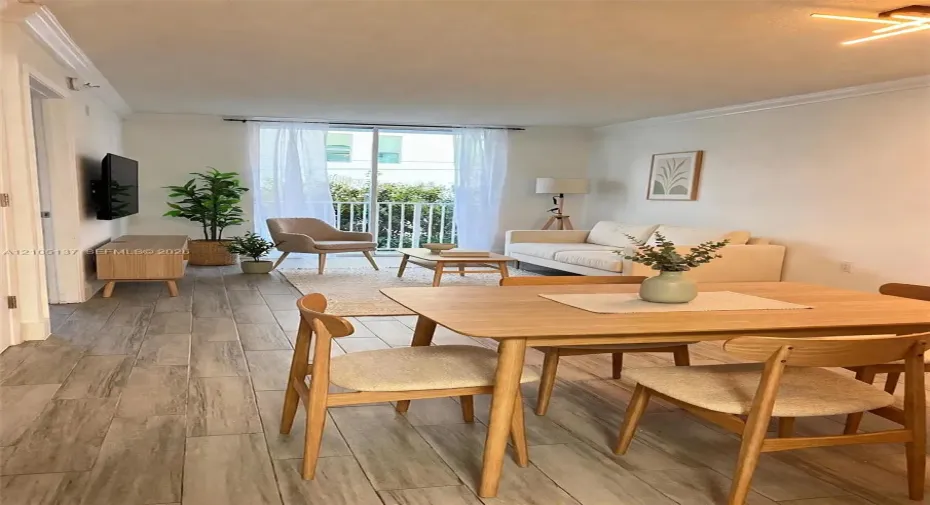 Open concept living space featuring wood-finish flooring, sliding glass doors to a balcony, and a contemporary ceiling light fixture