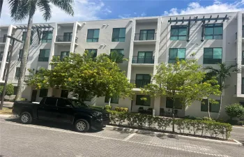 Multi-story structure with private balconies, contemporary windows, and architectural pergolas