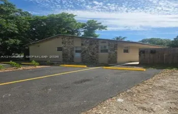 Asphalt parking area with yellow striping and parking blocks