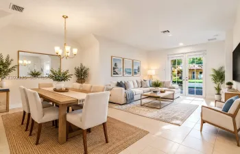 Virtually Stage - Open-concept area featuring high vaulted ceilings, large-format tile flooring, a brass-finish chandelier, and glass-paned French doors