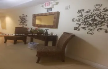 Neutral-toned ceramic tile flooring throughout, accented by decorative wrought iron wall sconces