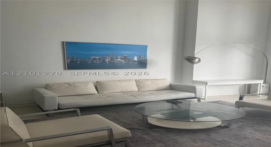 High-ceiling interior space featuring neutral wall finishes and large-format tile flooring