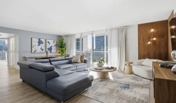 Open-concept living space featuring wood-finish flooring, floor-to-ceiling glass sliding doors, and a wood-paneled accent wall with integrated multi-globe lighting