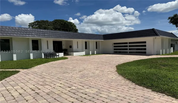 White stucco exterior with a dark tile roof