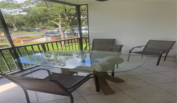 Screen-enclosed porch featuring tile flooring and metal frame construction
