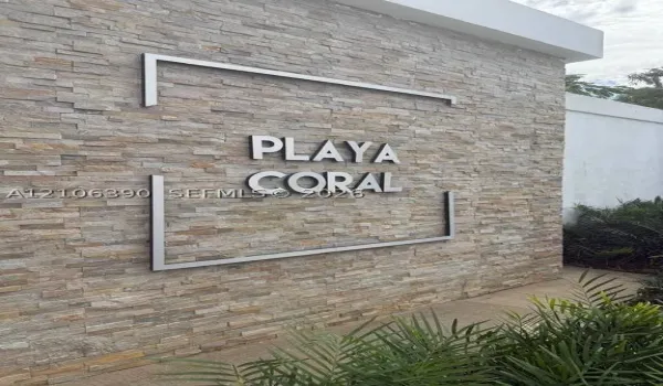 Stacked stone masonry wall featuring three-dimensional metal lettering and linear metal framing