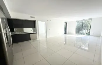 Large-format tile flooring, flat-panel dark cabinetry, stainless steel appliances, and floor-to-ceiling glass sliding doors