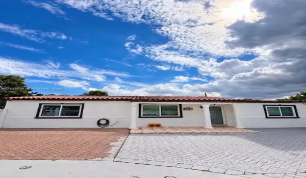 White stucco exterior with a terra cotta tile roof