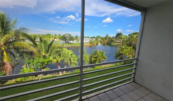 Screened-in balcony featuring ceramic tile flooring, metal frame, and direct water frontage