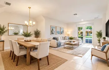 Virtually Stage - Open-concept area featuring high vaulted ceilings, large-format tile flooring, a brass-finish chandelier, and glass-paned French doors