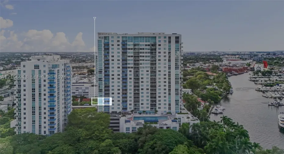 High-rise residential building featuring floor-to-ceiling glass windows, exterior balconies, and an elevated outdoor swimming pool