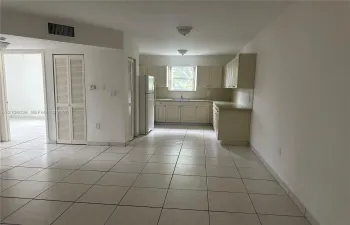 Kitchen featuring cabinetry with integrated storage, tile flooring, and flush-mount ceiling lighting
