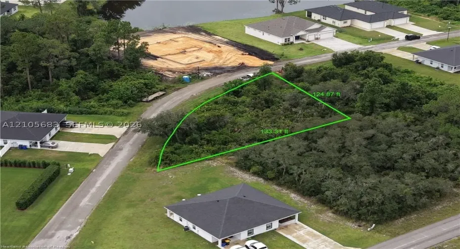 Vacant land parcel featuring mature trees, native vegetation, and defined property boundaries