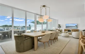 Floor-to-ceiling glass paneling, overhead multi-light pendant fixture, and large-format tile flooring