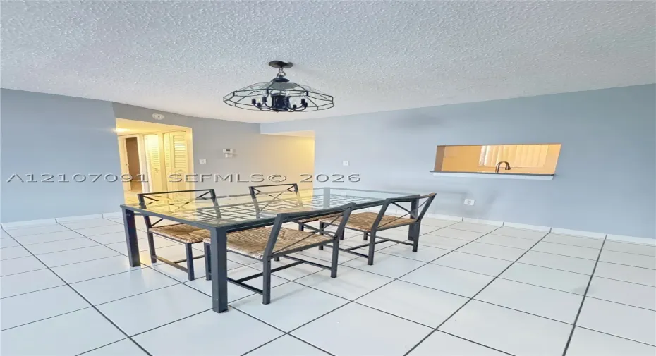 Ceramic tile flooring, geometric metal-framed overhead lighting, and an interior pass-through window with a ledge