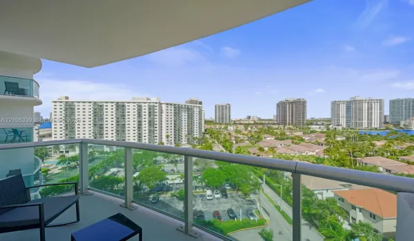 Expansive balcony with glass railings and city scenery
