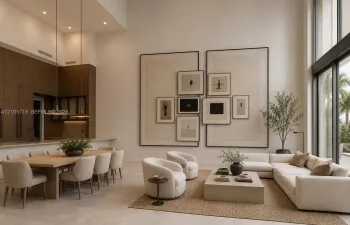 Double-height ceilings, floor-to-ceiling windows, custom built-in wall paneling, full-height dark wood-finish cabinetry, and neutral stone-finish flooring