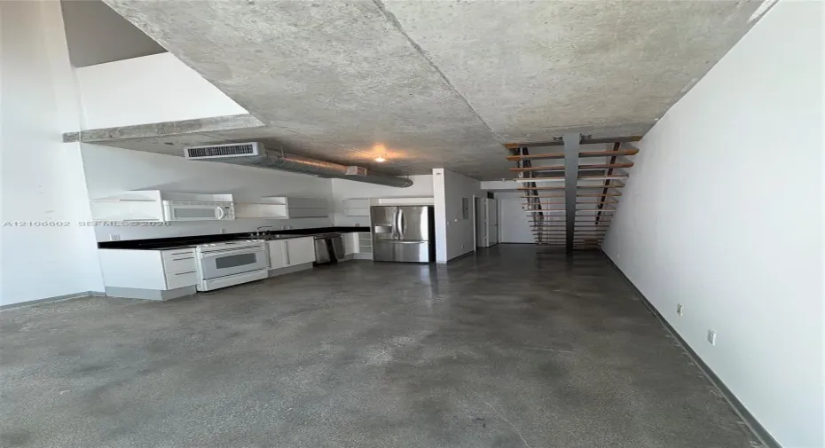 Industrial-style interior featuring exposed concrete ceilings and polished concrete flooring