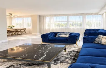 Polished stone-finish flooring, floor-to-ceiling windows, and recessed ceiling lighting