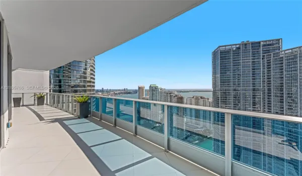 Private terrace with glass railing, looking out over the Miami River and the bay.