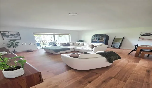 Interior space featuring wood-finish flooring, recessed lighting, and a sliding glass door providing exterior access