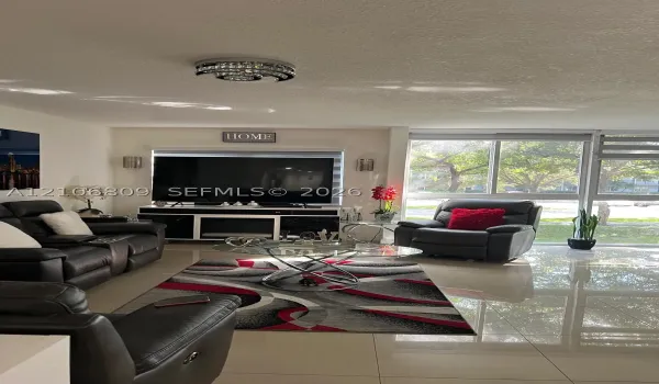 Polished tile flooring, floor-to-ceiling windows, and decorative chrome-finish flush mount lighting