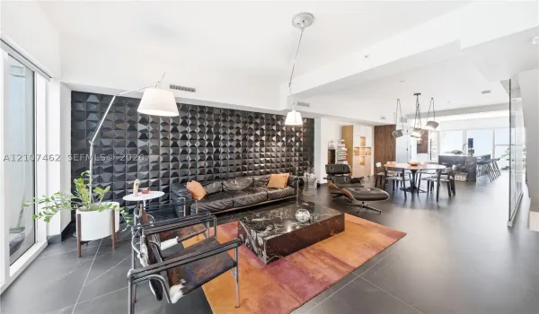 Textured black accent wall, large-format tile flooring, and integrated ceiling lighting fixtures