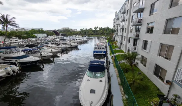 Waterfront multi-story building featuring structural balconies and direct access to boat slips